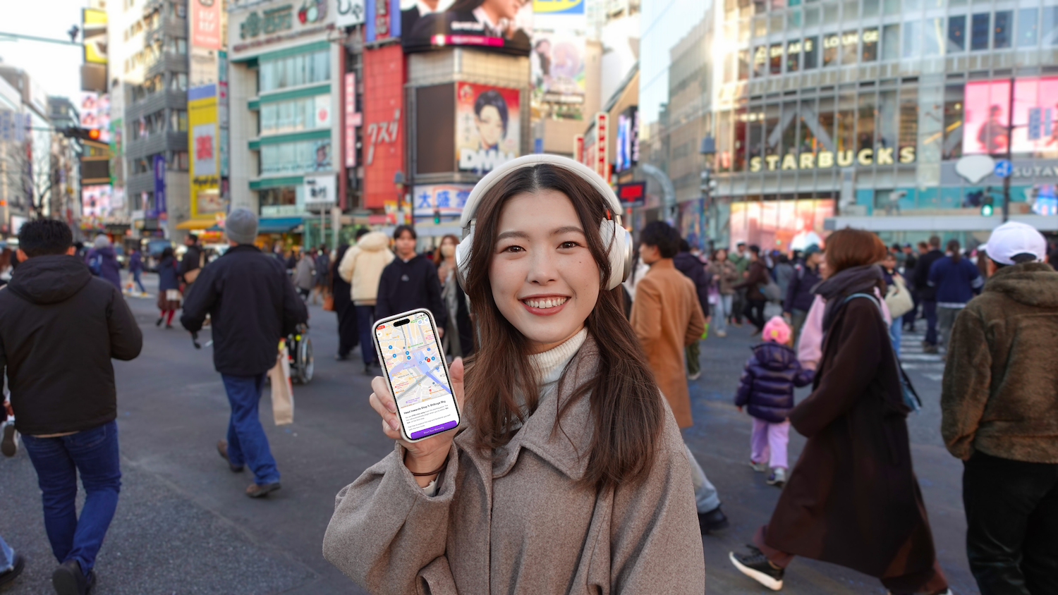 Sayaka from Nihongodekita showing the travel app in Shibuya
